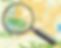 A magnifying glass on top of a street map