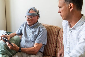 A man wearing a headset for a brainwave test